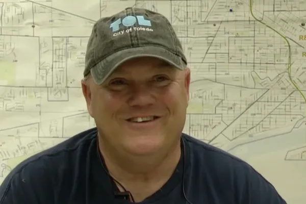 Photo of middle-aged white man in City of Toledo cap and similing during an interview. Photo credit: Channel 13 WTVG News