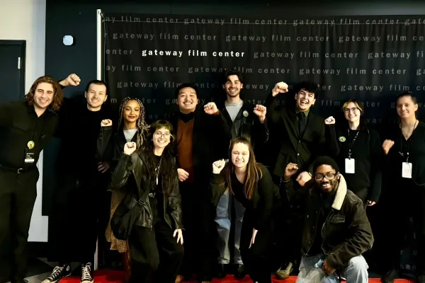 Photo of Gateway Film Center workers with fists up smiling