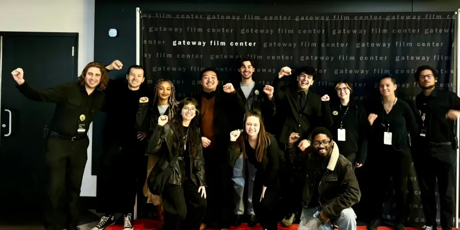 Photo of Gateway Film Center workers with fists up smiling